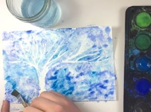 This winter art project for kids is so easy and BEAUTIFUL! Make a winter tree using white crayon and paint! A great winter craft for preschoolers and kids of ALL ages! #HowWeeLearndotcom #winterart #artprojectsforkids #crayonresist #paintingideas #watercolor #kidscrafts #artsandcrafts #artsandcraftsforkids
