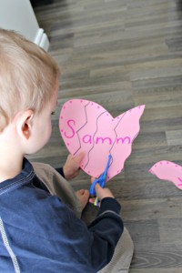 preschooler cutting out a heart for a valentines day craft