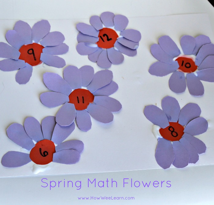 Spring math flowers with purple petals, orange middles with numbers on them.