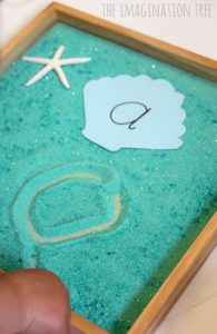 Learning the alphabet this summer - beach writing tray