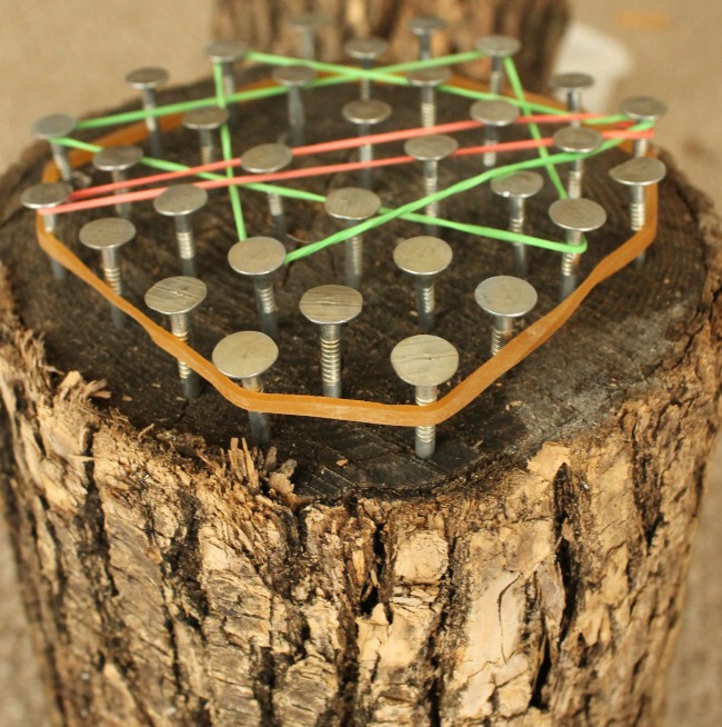 Hammering nails into a wood stump to make a geoboard. A great woodworking project for kids using real tools