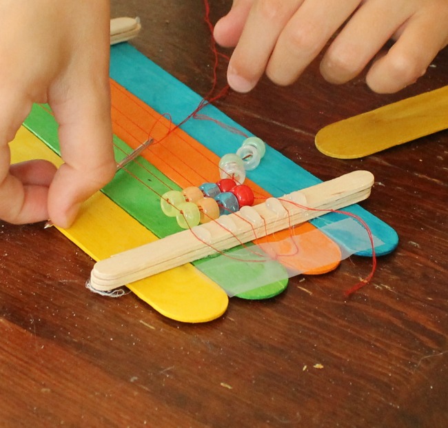 A DIY bead loom made from popsicle sticks. Perfect for making homemade beaded bracelets. #DIY #tutorial #beadloom #bracelets #ponybeads #crafts