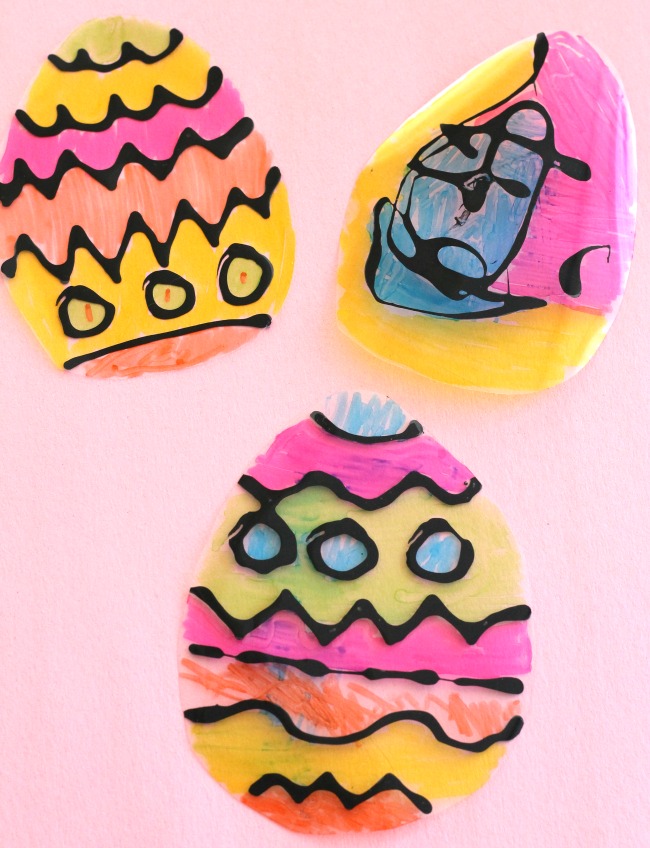 Such an easy idea for Easter crafts for kids! These black glue Easter egg suncatcher crafts are so pretty! #easter #eastercrafts ##eastercraftsforkids #howweelearn #craftsforkids #springcrafts #artsandcraftsforkids #artsandcrafts #blackglue #suncatcher