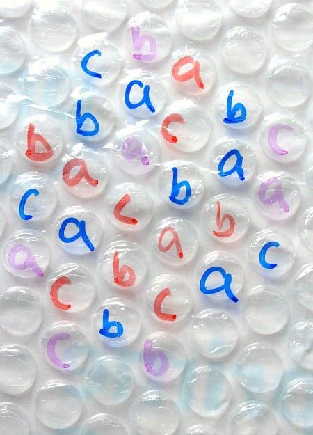 Who's up for a bubble wrap challenge? Challenge preschoolers to pop all the lower case letters or all the A's without popping other letters. This is a fantastic fine motor development activity! Keep learning fresh and exciting with this awesome collection of letter activities for preschool! #howweelearn #abc #alphabet #alphabetactivities #letters #lettersounds #preschool