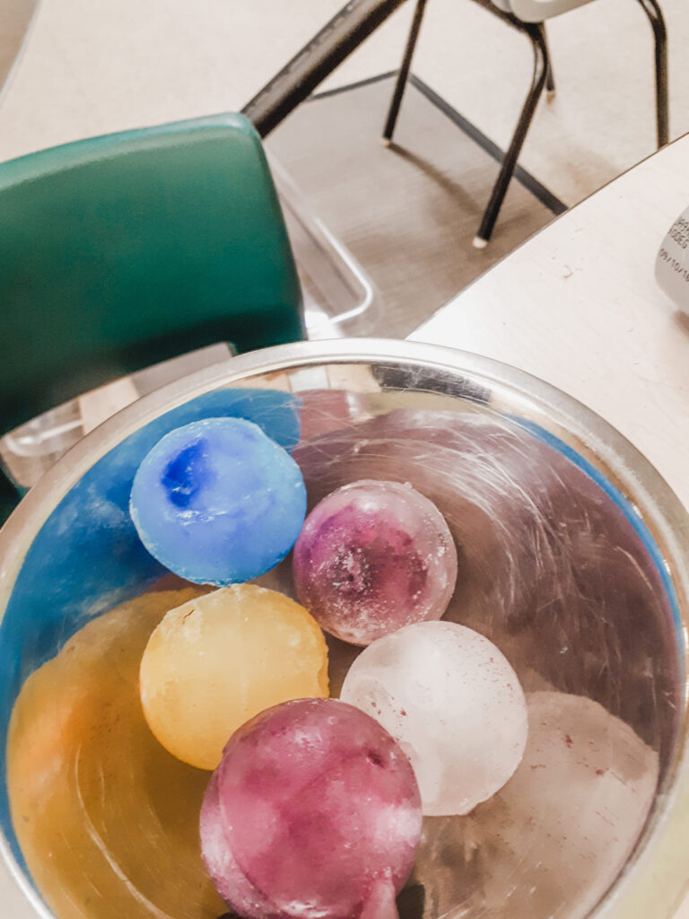 Frozen ice balls in different colours to teach preschoolers about colour mixing