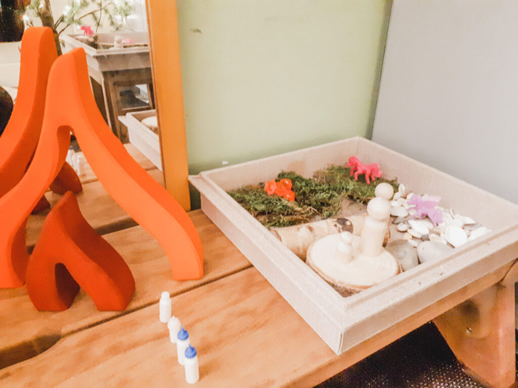 a quiet cozy space in the preschool classroom made of natural elements