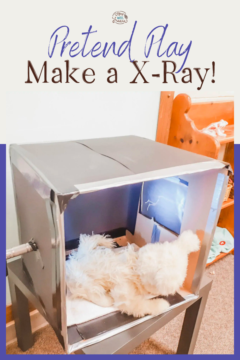 A stuffed bear in a homemade x-ray machine made from a cardboard box in a preschool classroom