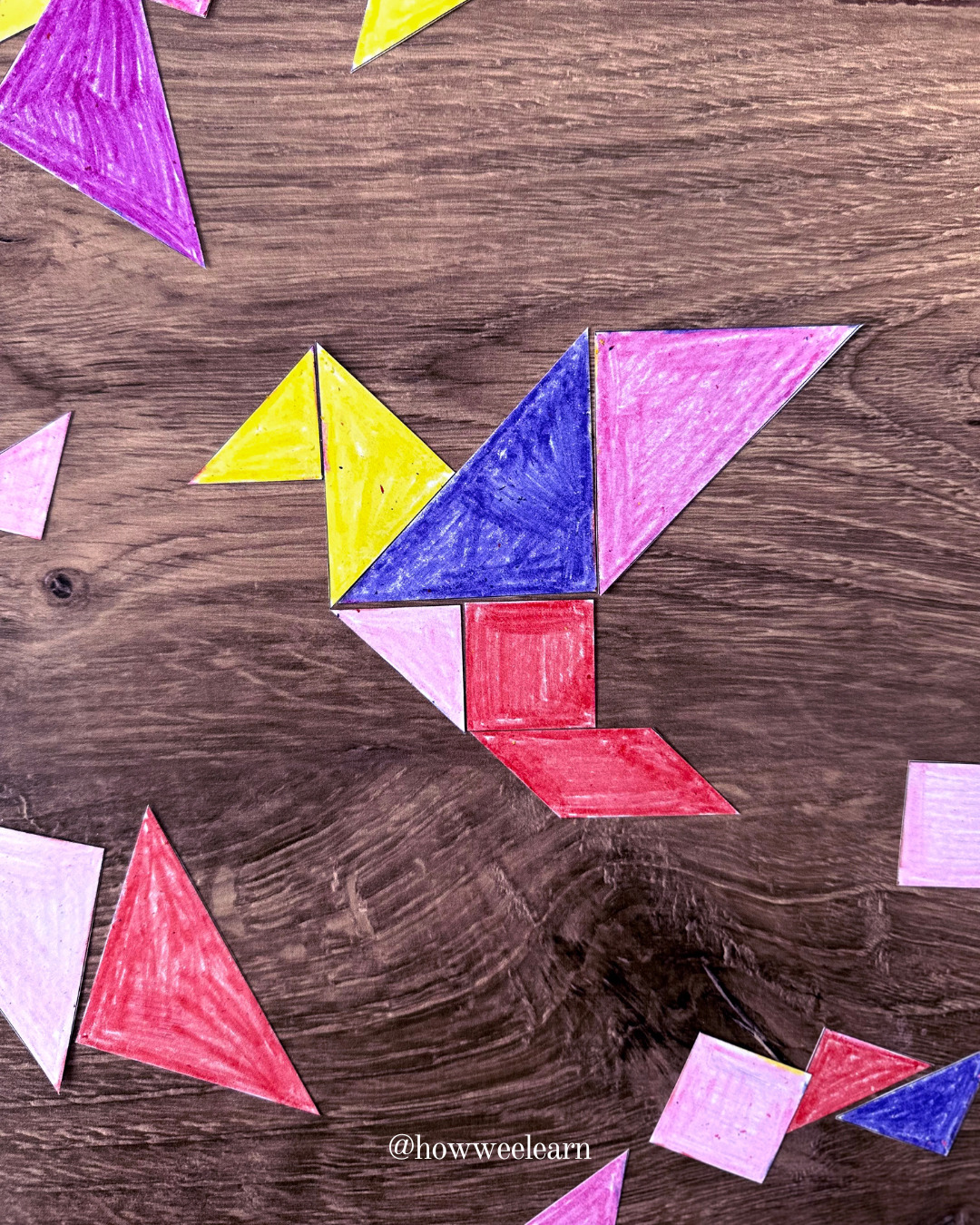 printable tangram puzzle pieces in the shape of a bird coloured with crayon