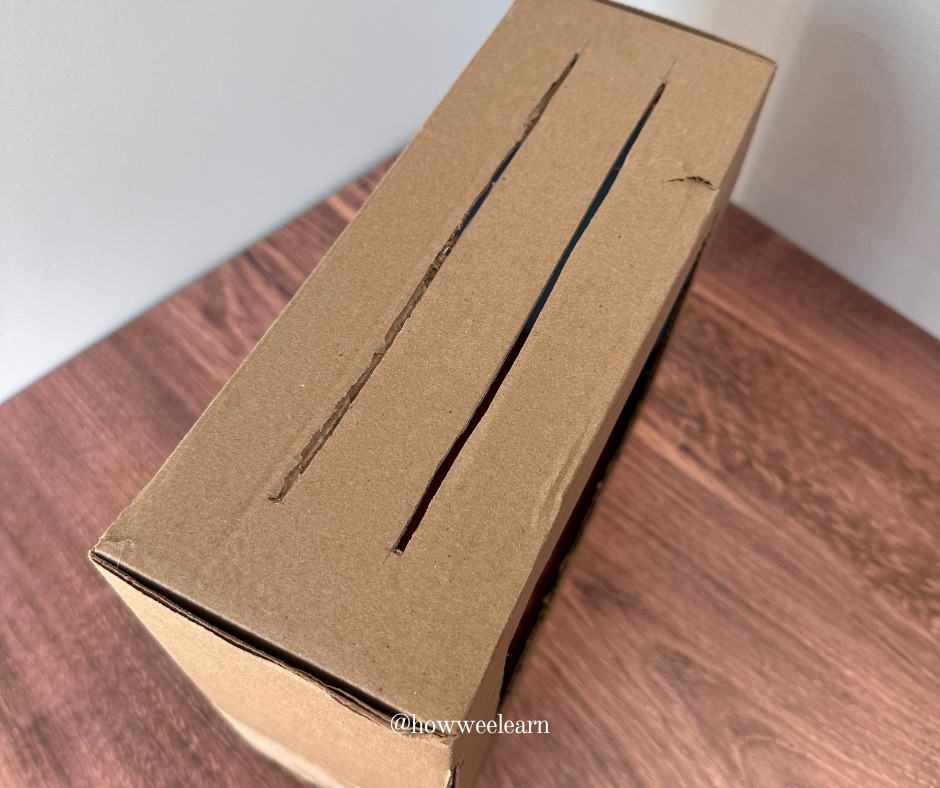 Cutting slits in the top of a cardboard box to use with stick puppets printable