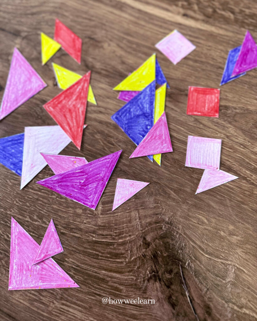 Printable tangram puzzle pieces coloured with crayons
