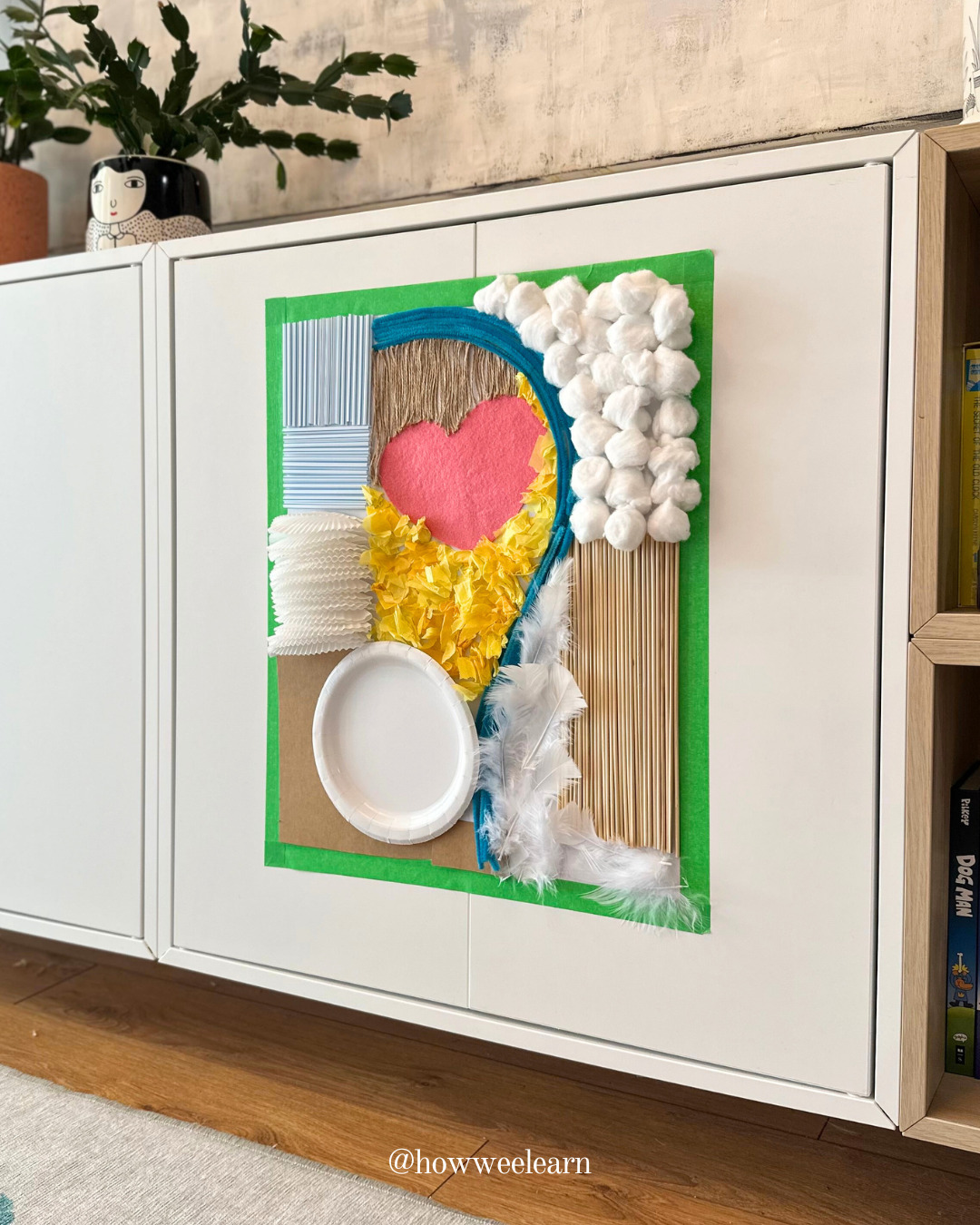 A sensory wall secured to a cabinet for toddlers