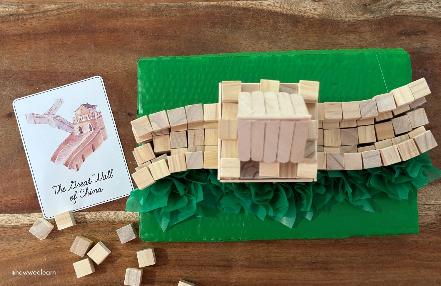 Building The Great Wall of China with small wooden blocks, aerial view