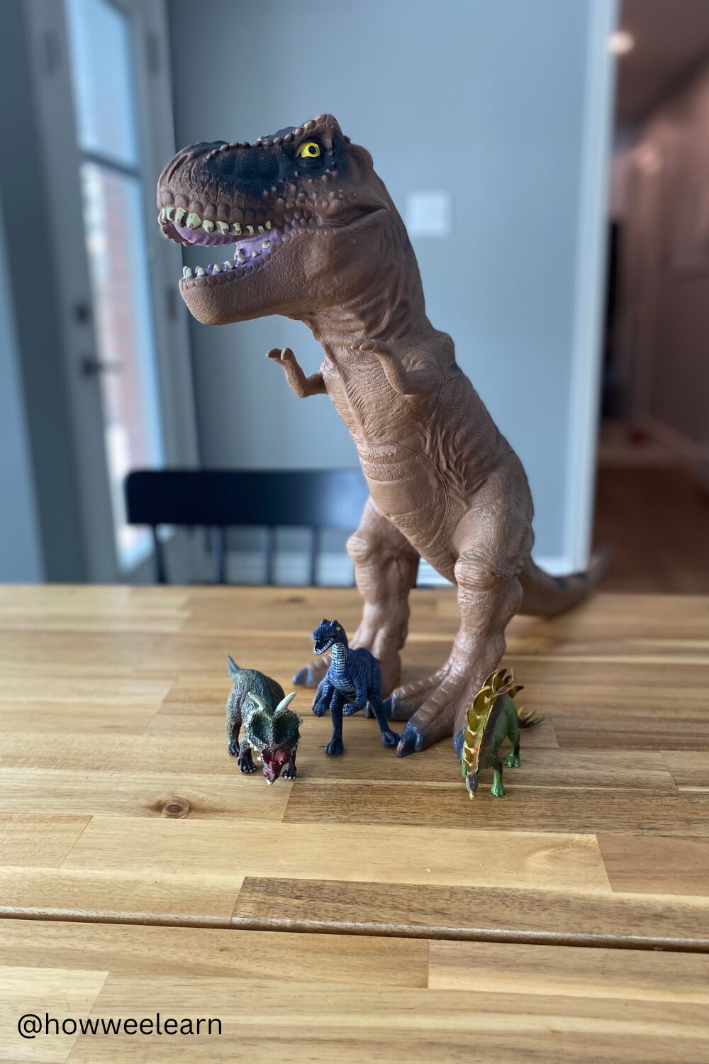 Toddler Game - One item doesn't belong - 3 small dinos and one large dino.