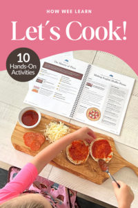 A child spreads tomato sauce on English muffins next to shredded cheese, pepperoni, and a family unit study coursebook with the text “Let’s Cook! 10 Hands-On Activities.”