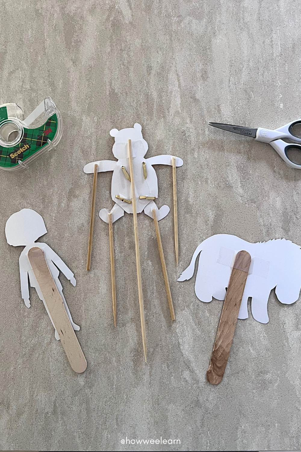 Tape Popsicle Sticks to the Puppets